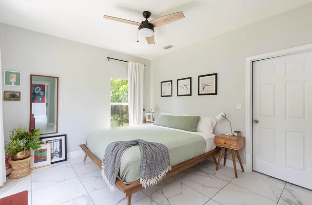 a bedroom with a bed and a potted plant