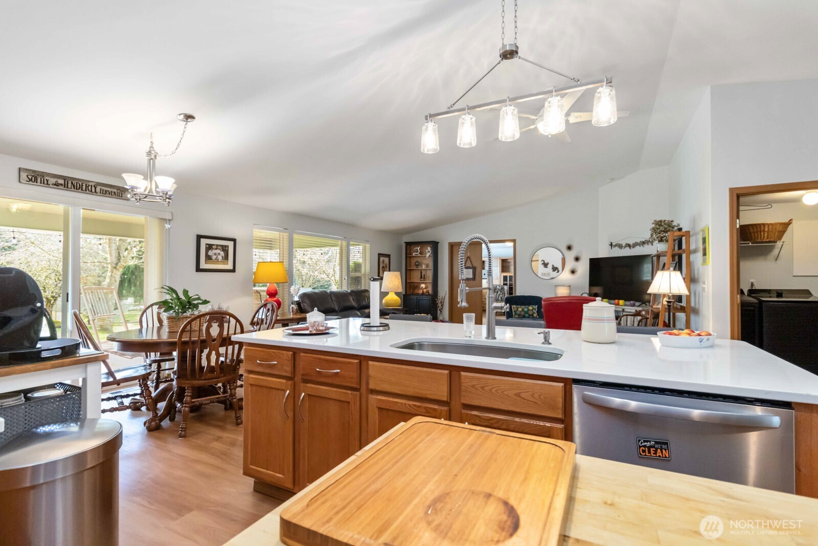 413 Haywire Road Winlock, WA 98596 - Photo 23 of 40 a large kitchen with a table chairs and flat screen tv