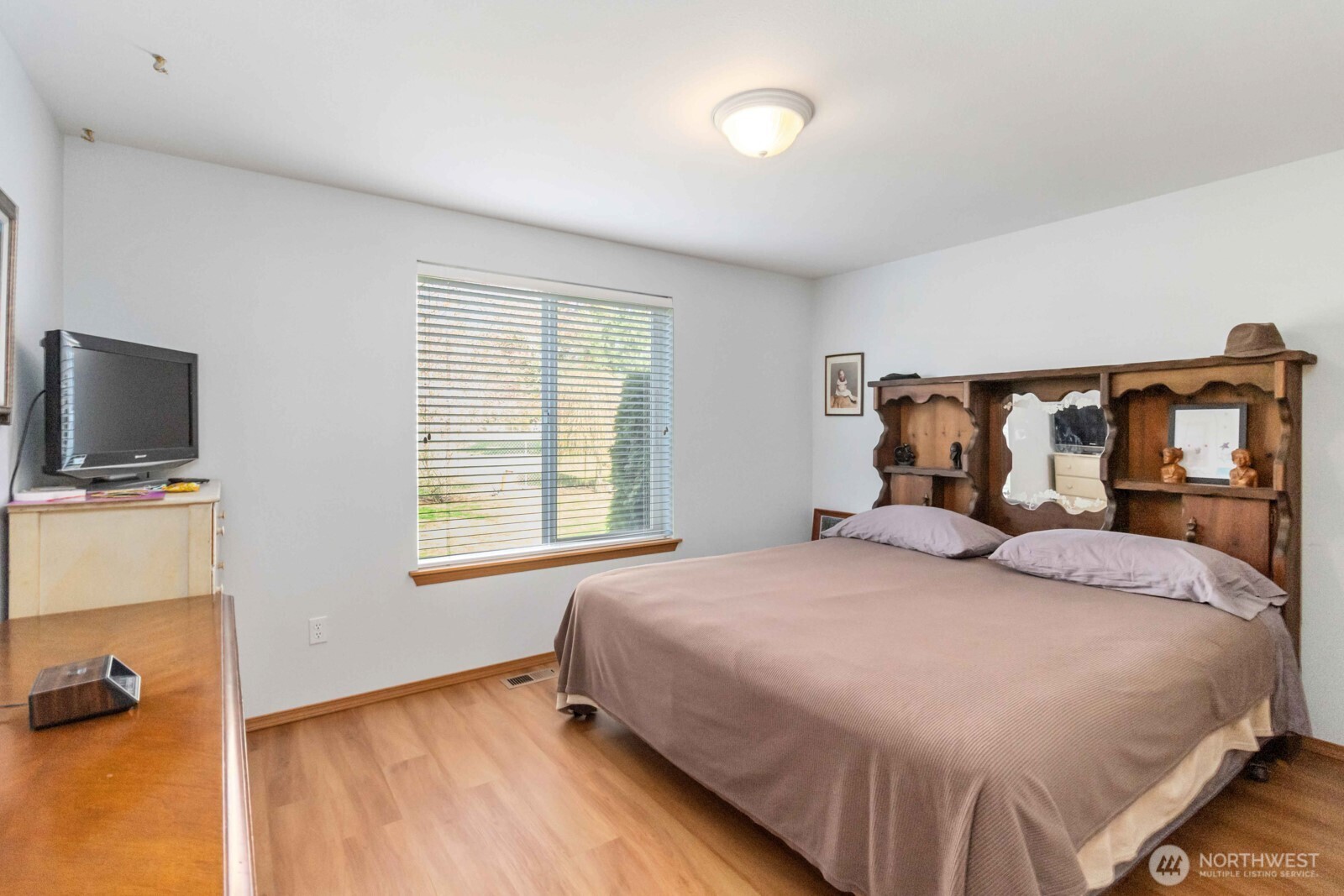 413 Haywire Road Winlock, WA 98596 - Photo 35 of 40 a bedroom with a bed and flat tv screen on the dresser