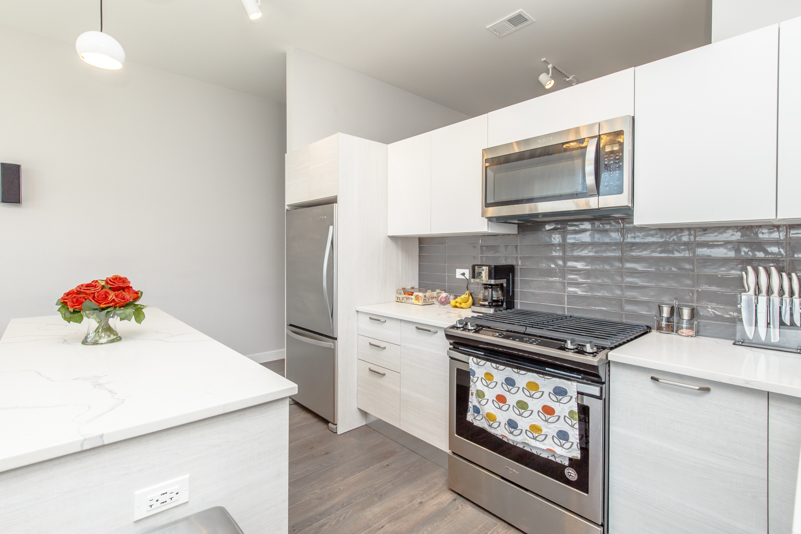 Undisclosed Address Chicago, IL 60610 - Photo 6 of 12 a kitchen with stainless steel appliances a stove microwave and cabinets
