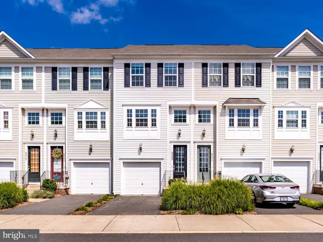 a front view of a residential apartment building with a yard