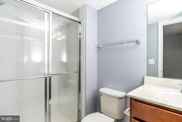 a bathroom with a shower a toilet and a sink