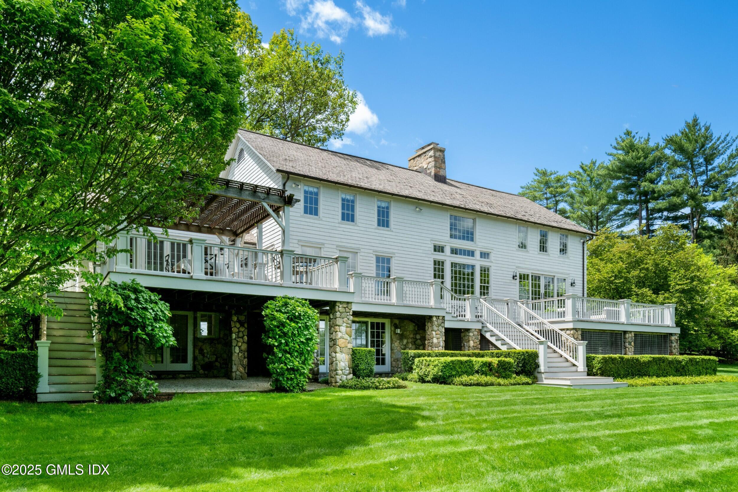 945 Oenoke Ridge New Canaan, CT 06840 - Photo 12 of 94 a view of house with a yard