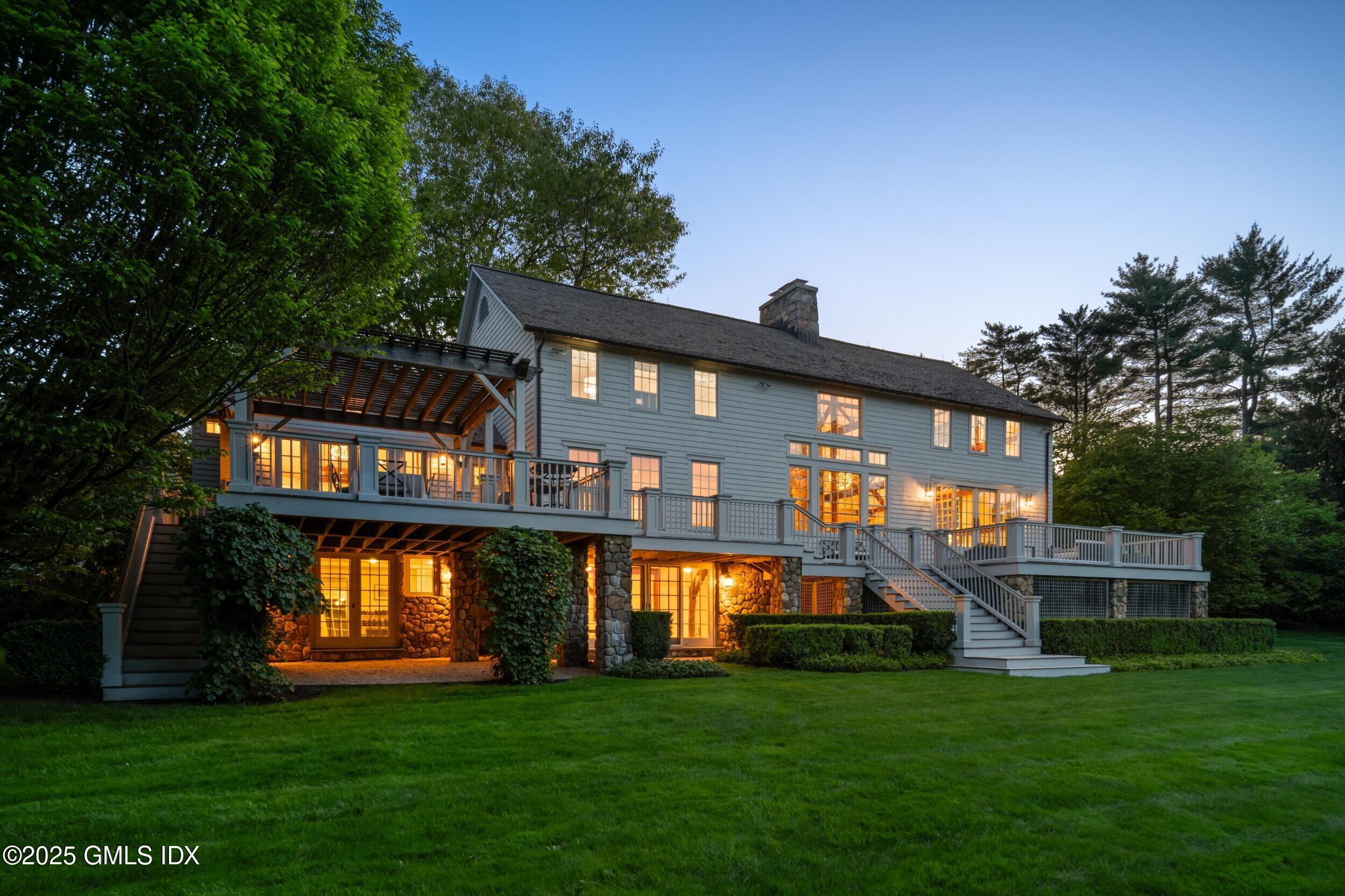 945 Oenoke Ridge New Canaan, CT 06840 - Photo 13 of 94 a front view of house with yard and green space