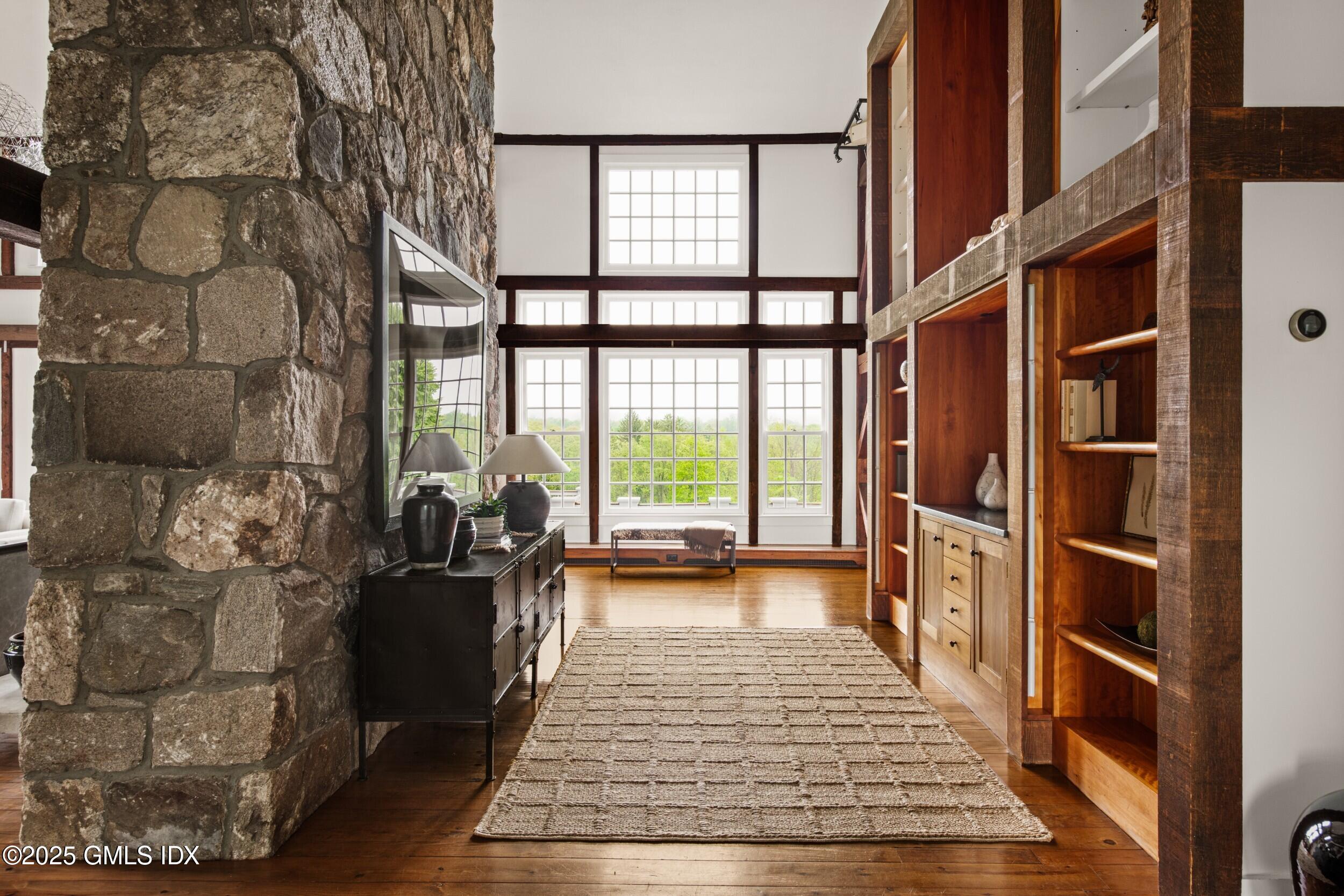 945 Oenoke Ridge New Canaan, CT 06840 - Photo 17 of 94 a view of a living room and a window in the city street