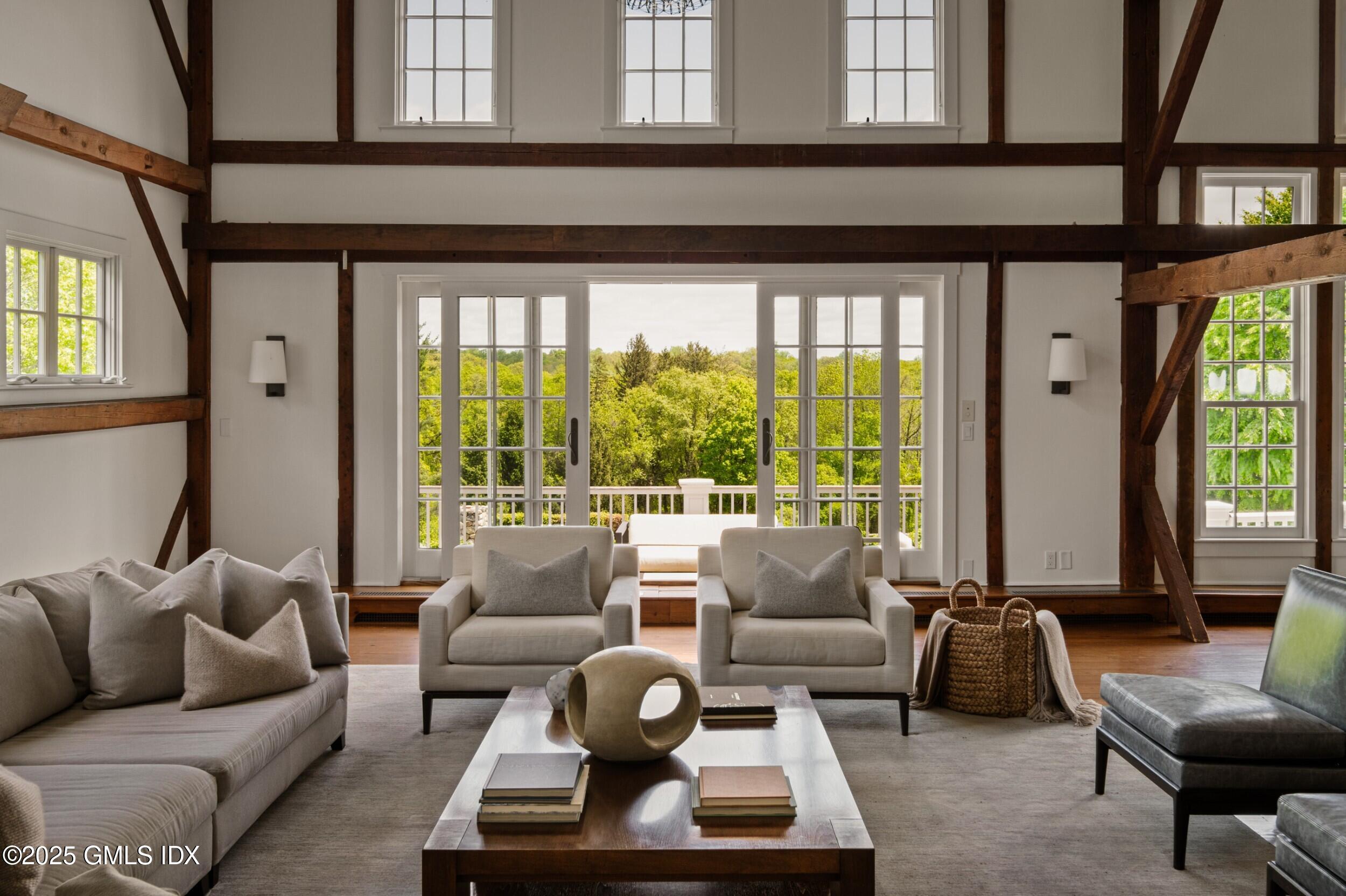 945 Oenoke Ridge New Canaan, CT 06840 - Photo 25 of 94 a living room with furniture and a large window