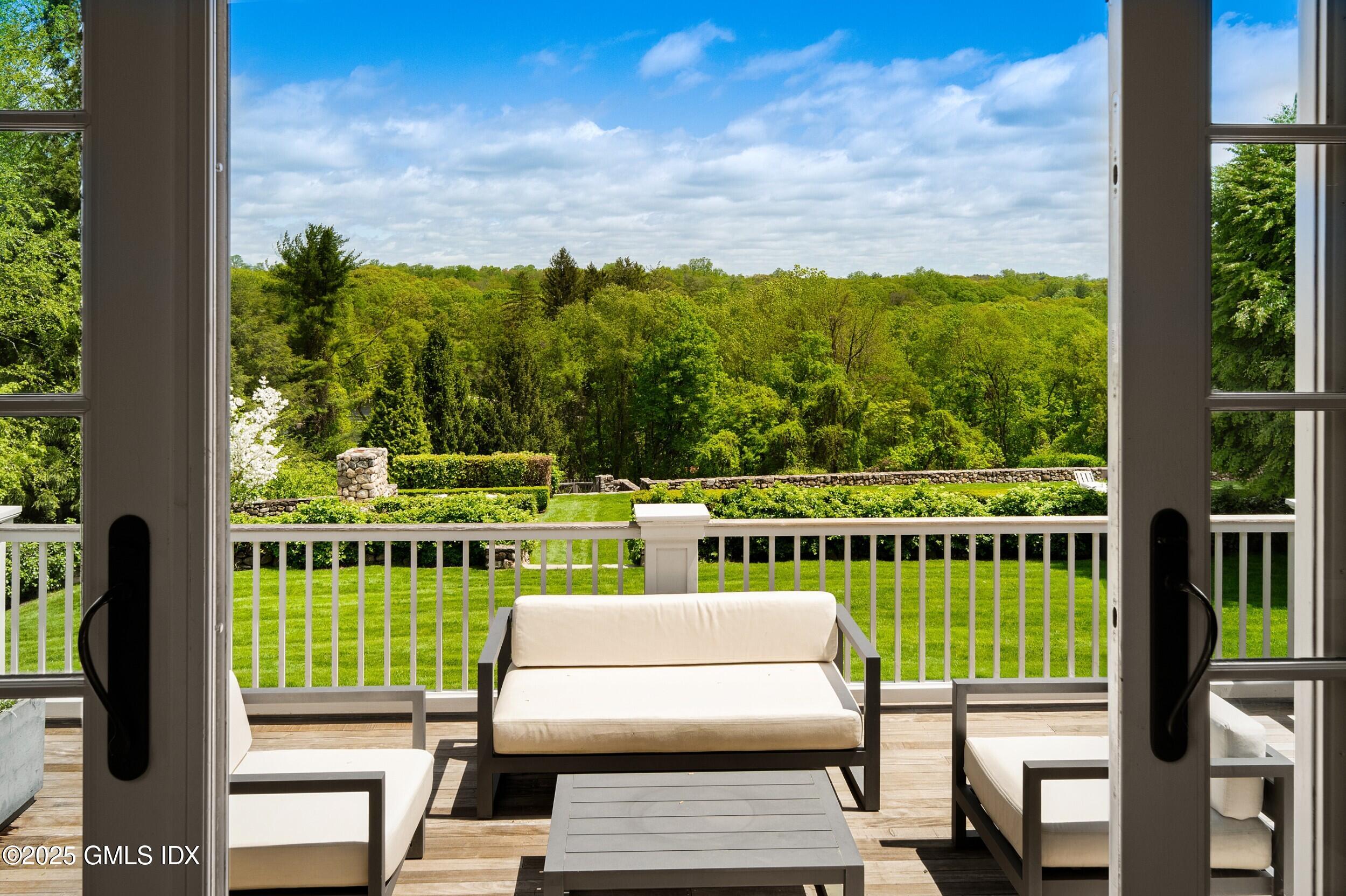 945 Oenoke Ridge New Canaan, CT 06840 - Photo 26 of 94 a view of a chairs and table on the balcony