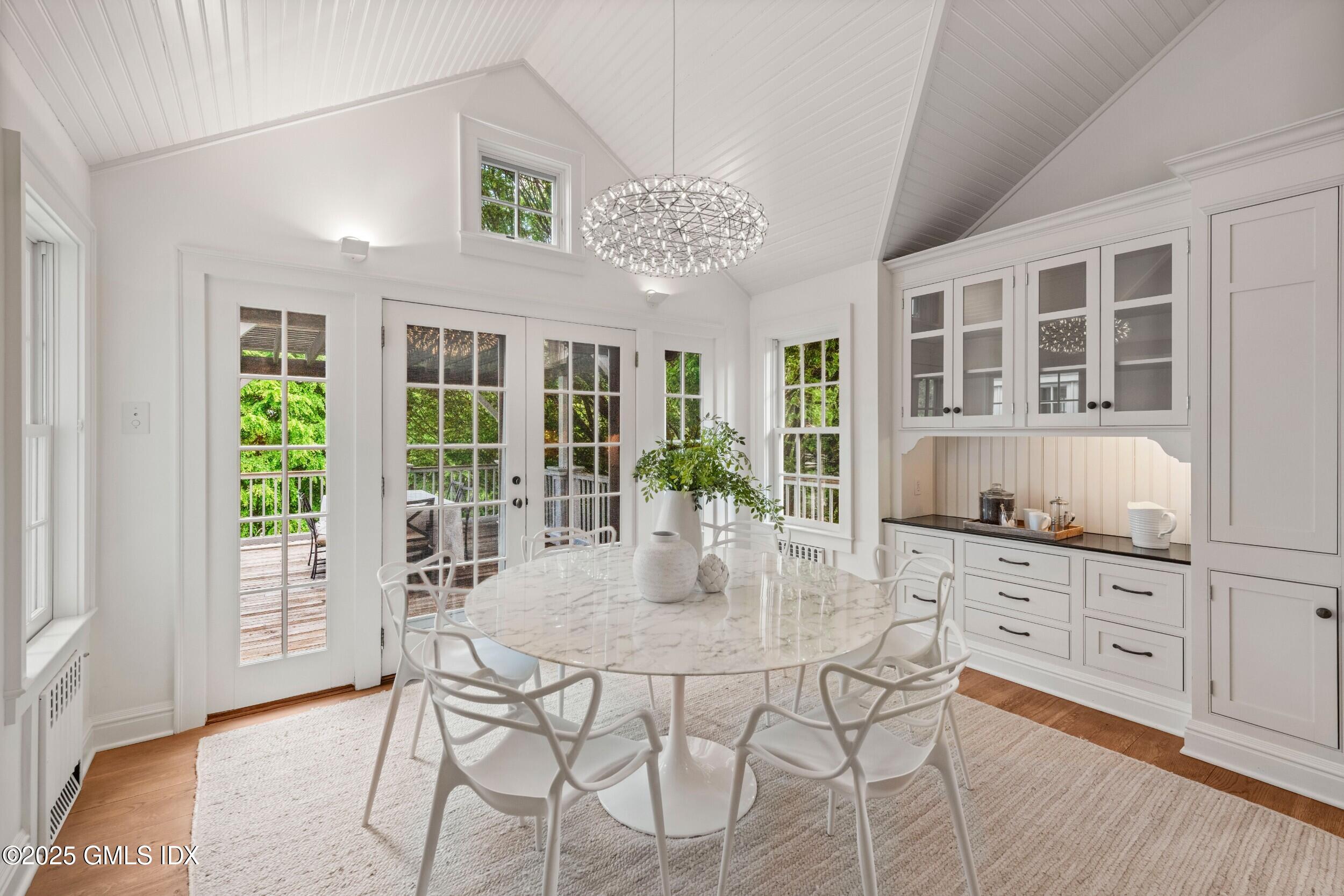 945 Oenoke Ridge New Canaan, CT 06840 - Photo 32 of 94 a kitchen with granite countertop a stove a table and chairs in it