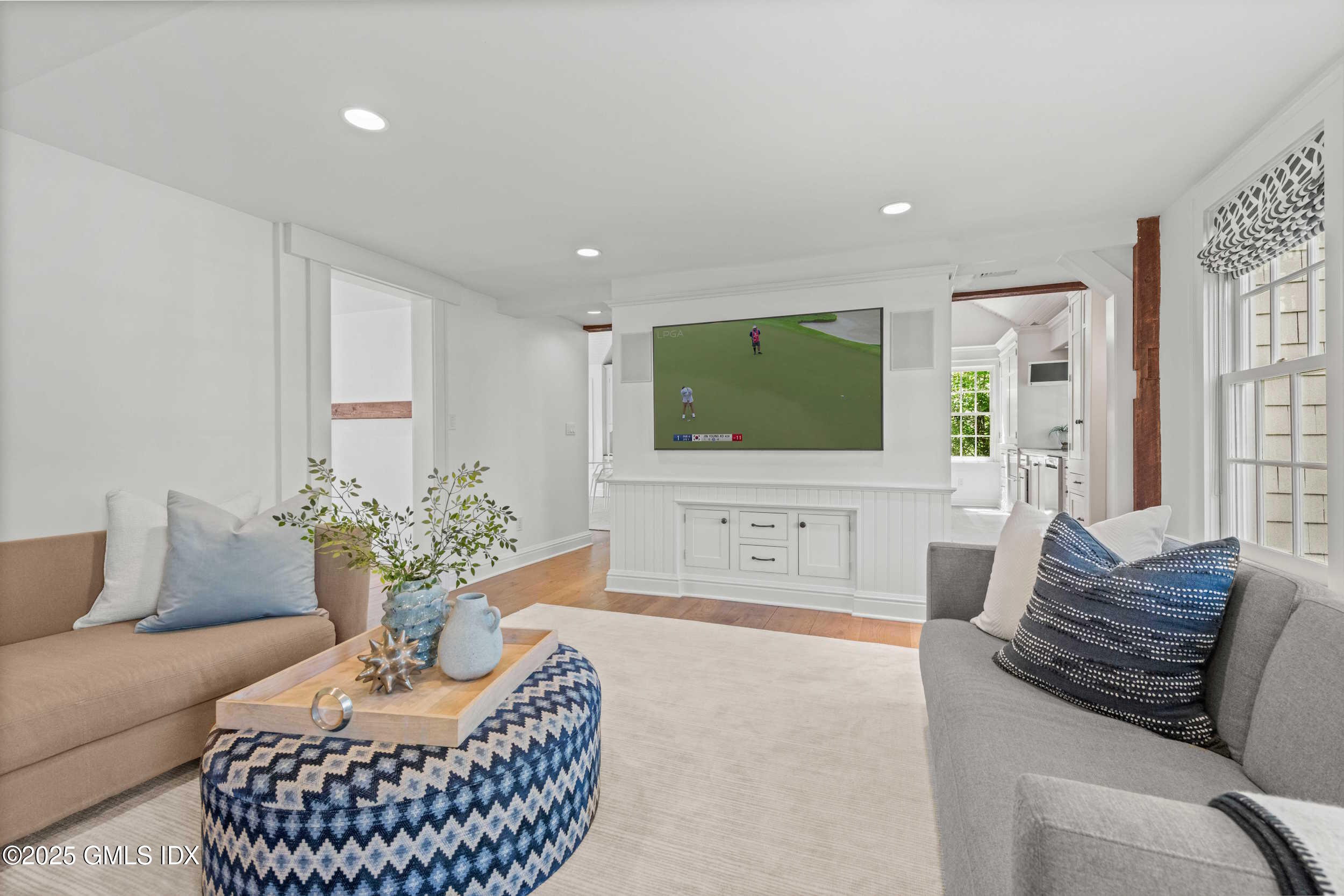 945 Oenoke Ridge New Canaan, CT 06840 - Photo 38 of 94 a living room with furniture a flat screen tv and a large window
