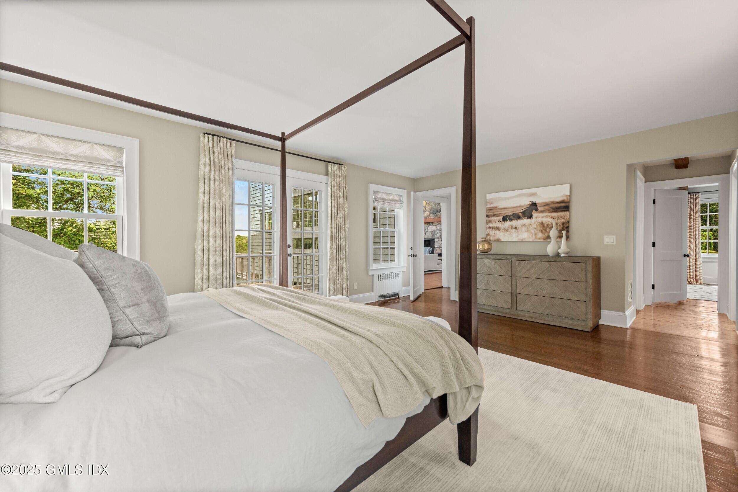 945 Oenoke Ridge New Canaan, CT 06840 - Photo 41 of 94 a bed sitting in a spacious bedroom next to a window
