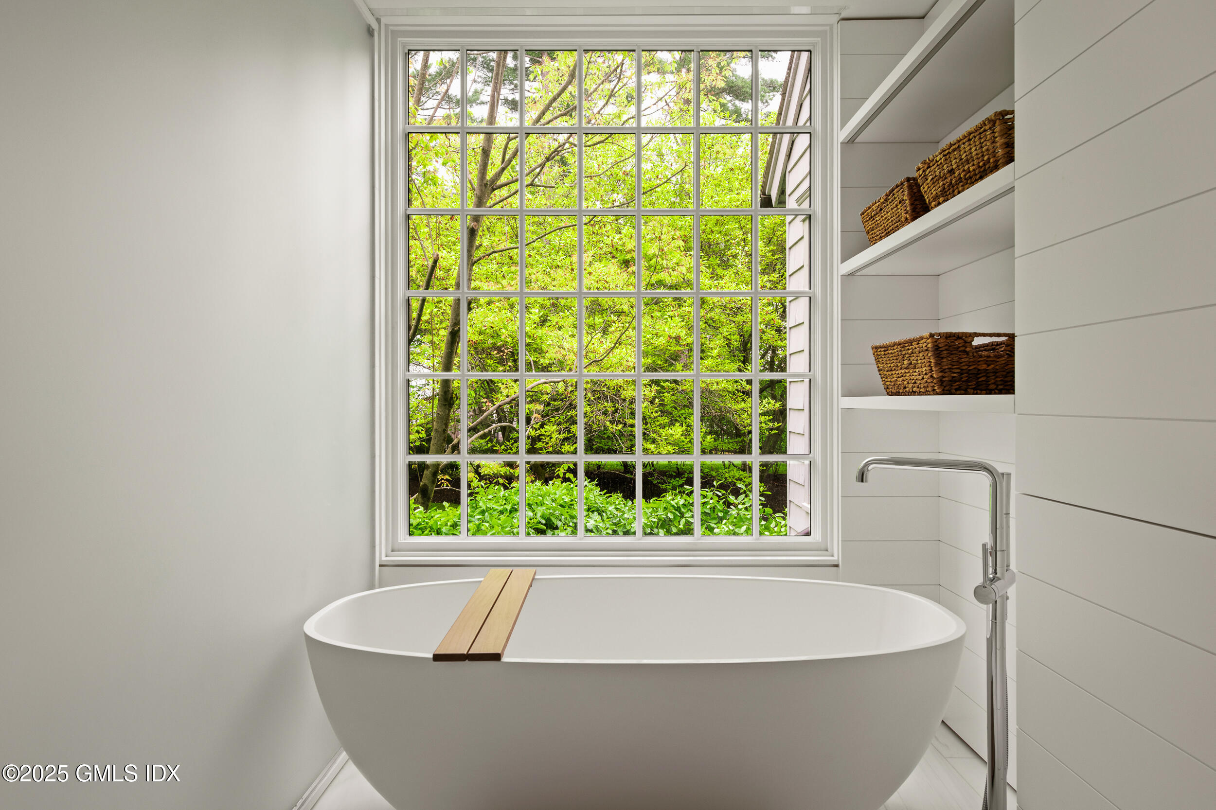 945 Oenoke Ridge New Canaan, CT 06840 - Photo 43 of 94 a white bath tub sitting in a bathroom next to a window