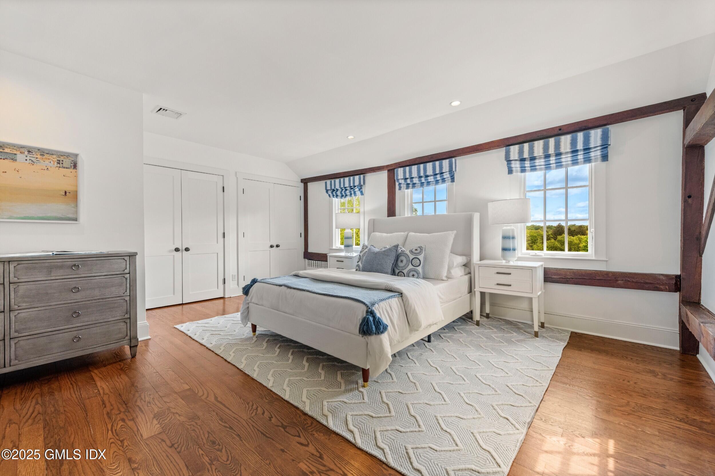 945 Oenoke Ridge New Canaan, CT 06840 - Photo 48 of 94 a spacious bedroom with a bed and a window