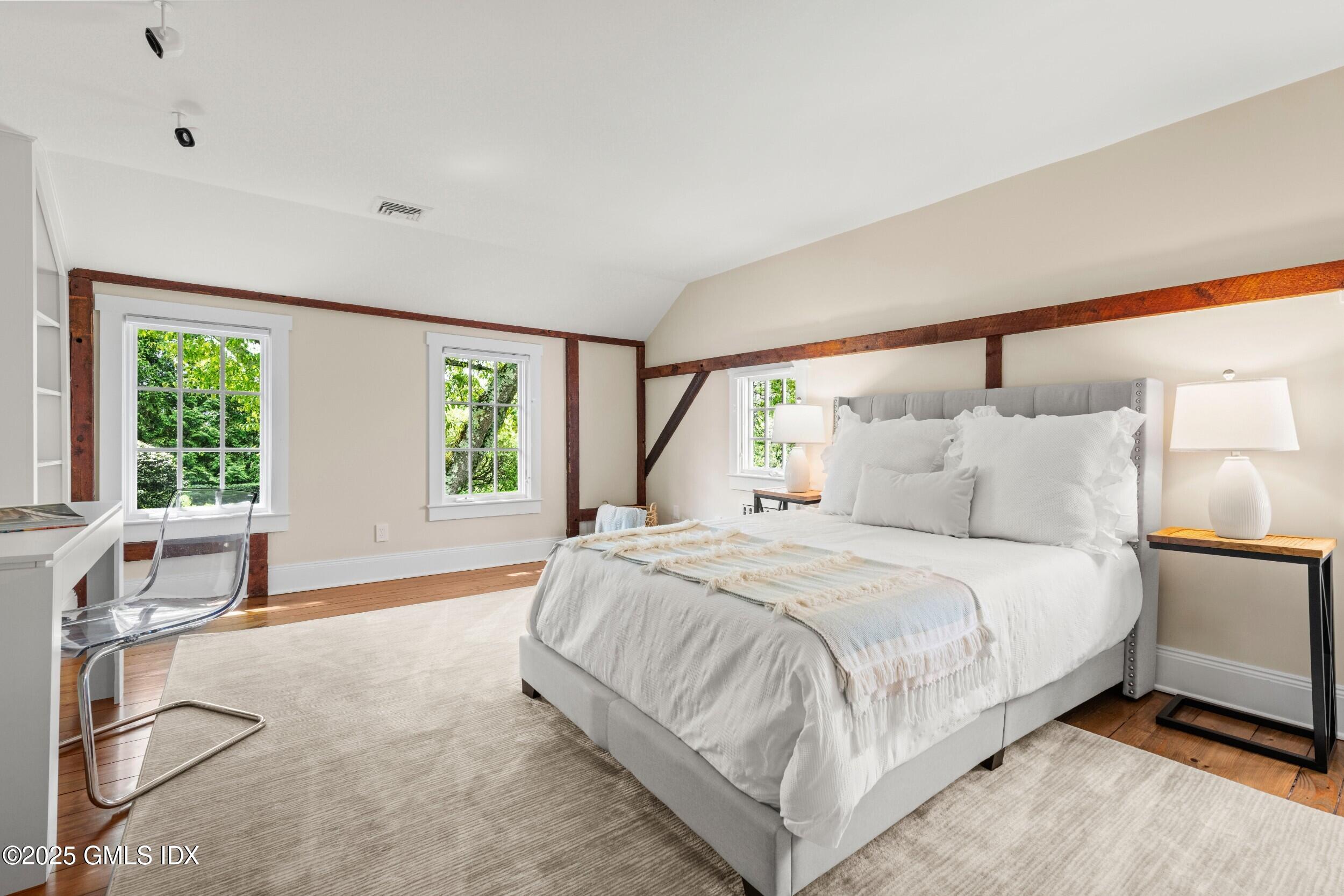 945 Oenoke Ridge New Canaan, CT 06840 - Photo 51 of 94 a large bed sitting in a bedroom next to a window