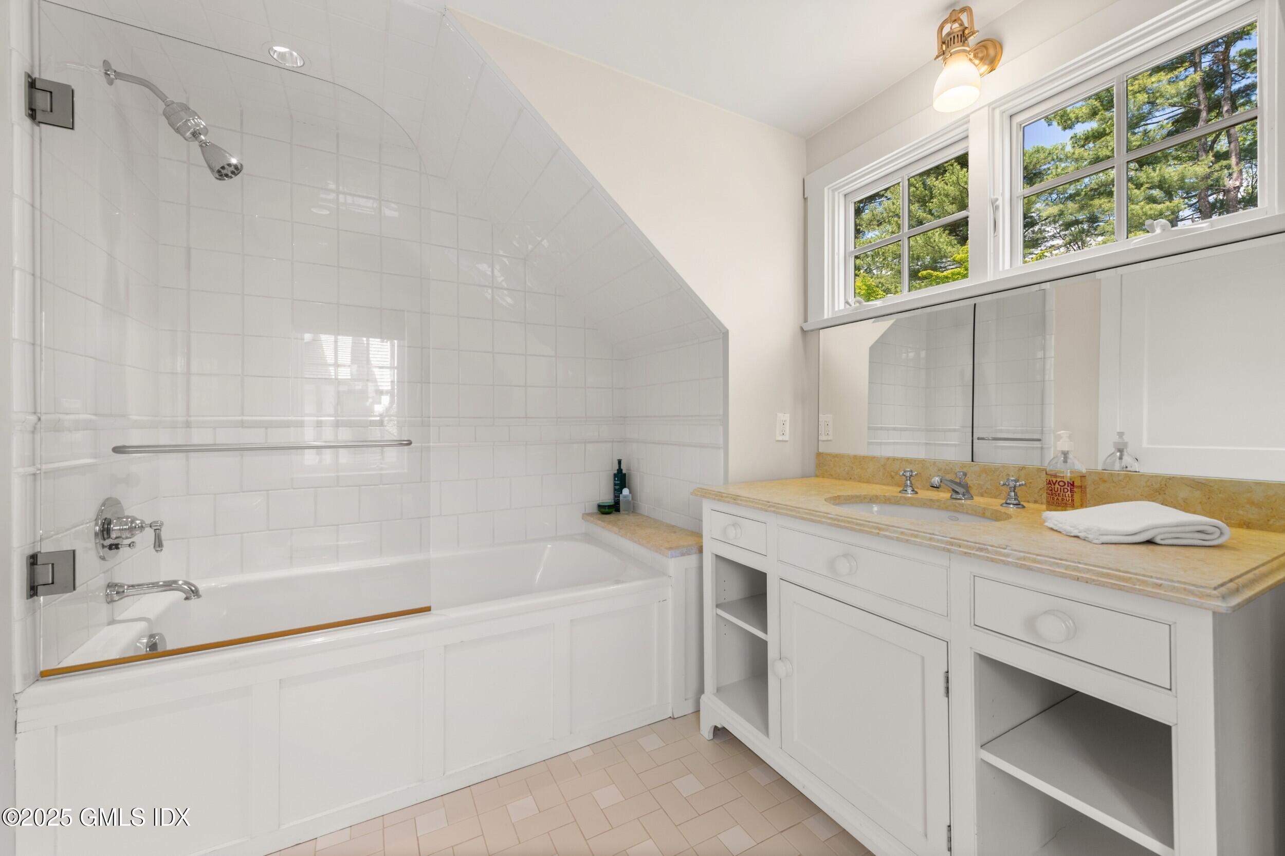 945 Oenoke Ridge New Canaan, CT 06840 - Photo 53 of 94 a bathroom with a sink and a bathtub