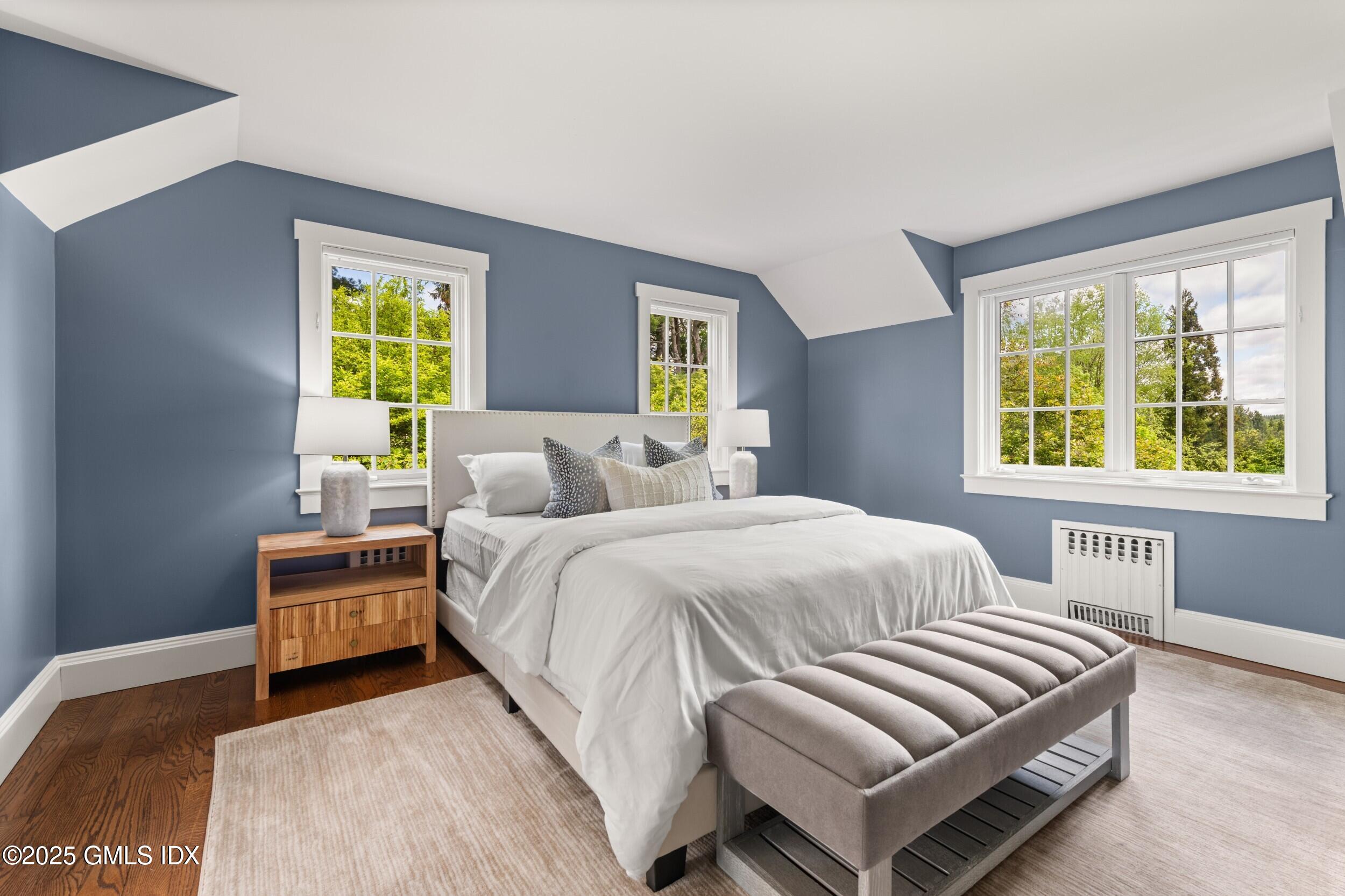 945 Oenoke Ridge New Canaan, CT 06840 - Photo 54 of 94 a bedroom with a bed and a window