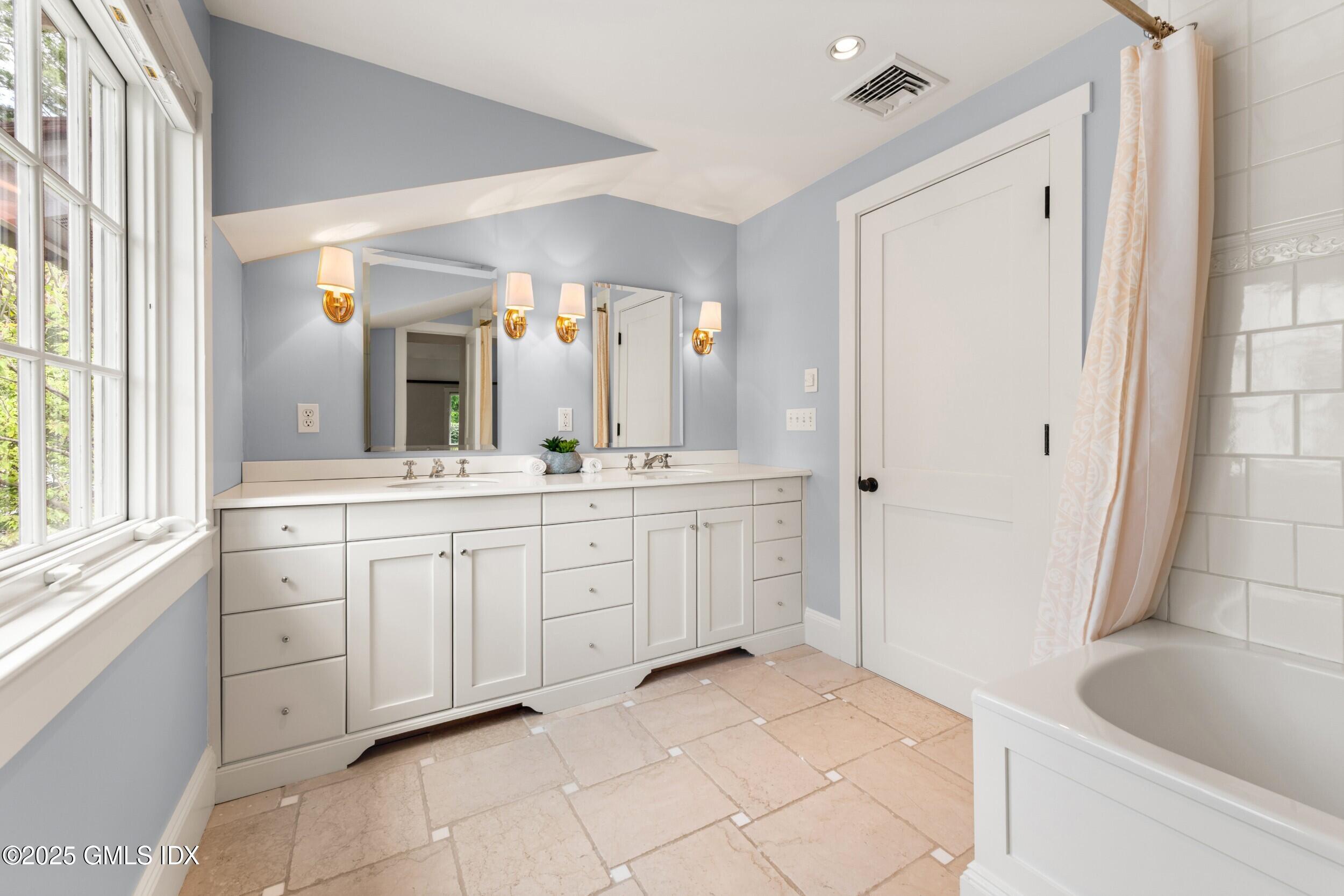945 Oenoke Ridge New Canaan, CT 06840 - Photo 56 of 94 a spacious bathroom with a granite countertop sink mirror and bathtub