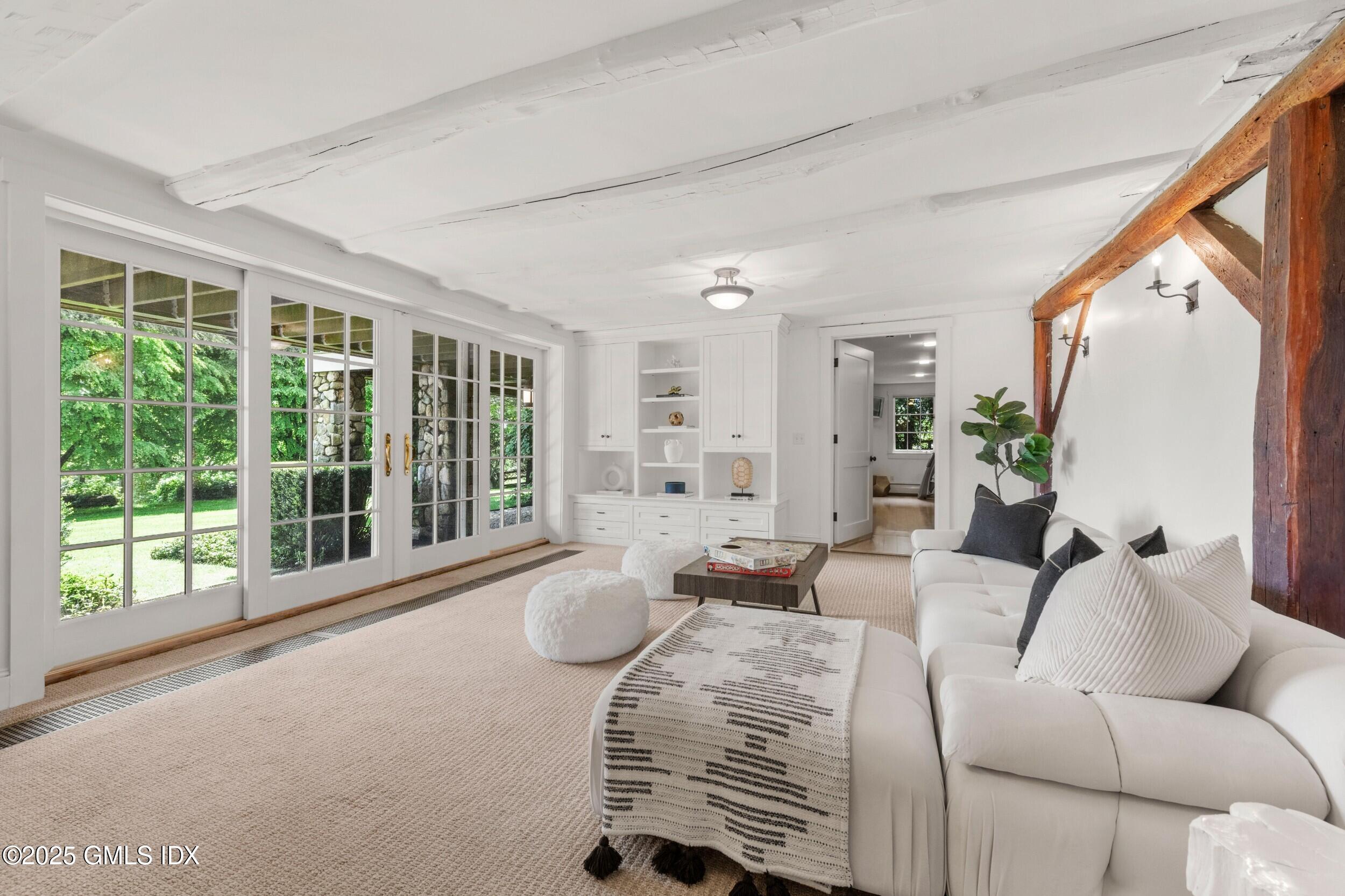 945 Oenoke Ridge New Canaan, CT 06840 - Photo 58 of 94 a living room with furniture and large windows