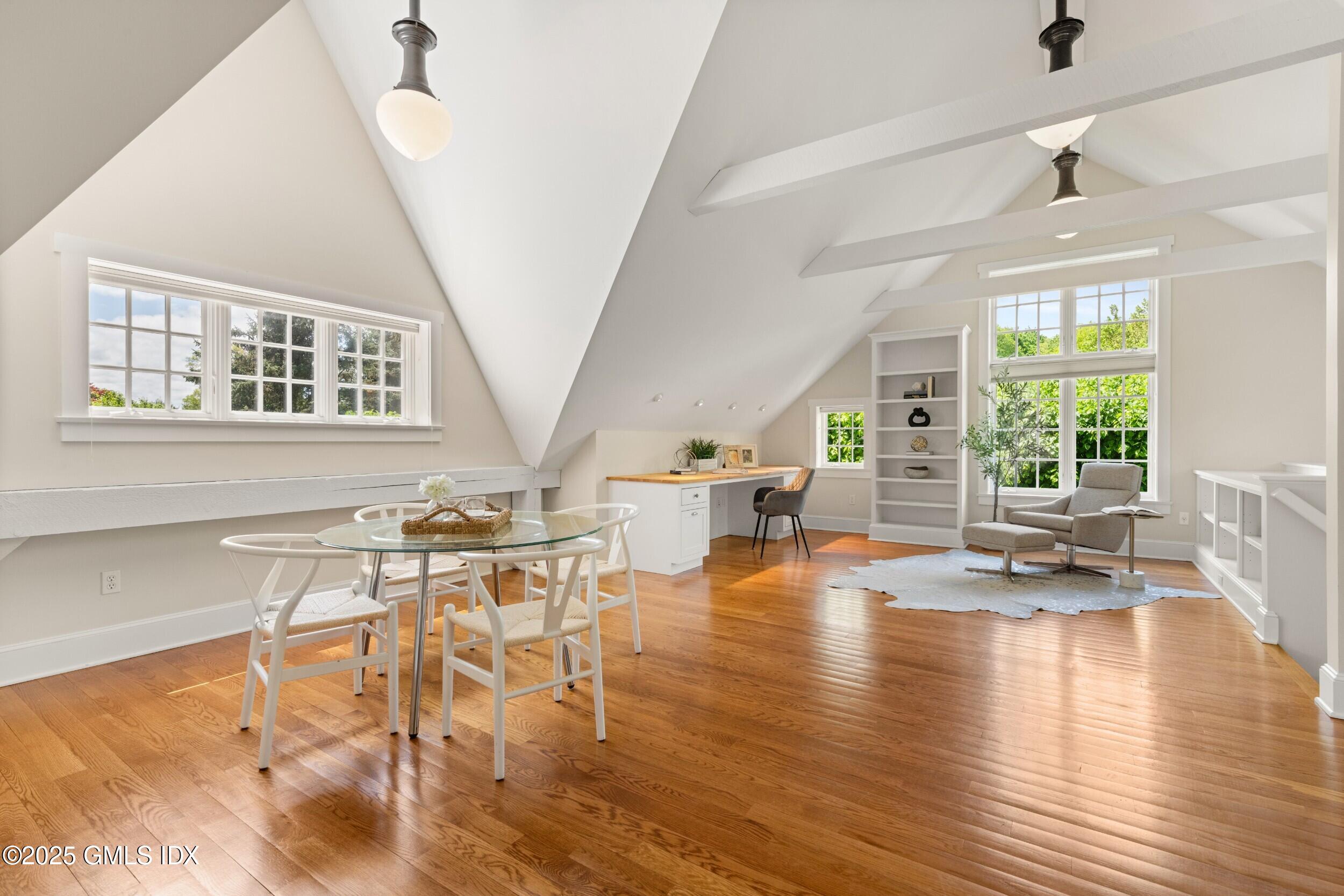 945 Oenoke Ridge New Canaan, CT 06840 - Photo 65 of 94 a view of a livingroom with furniture wooden floor and a chandelier