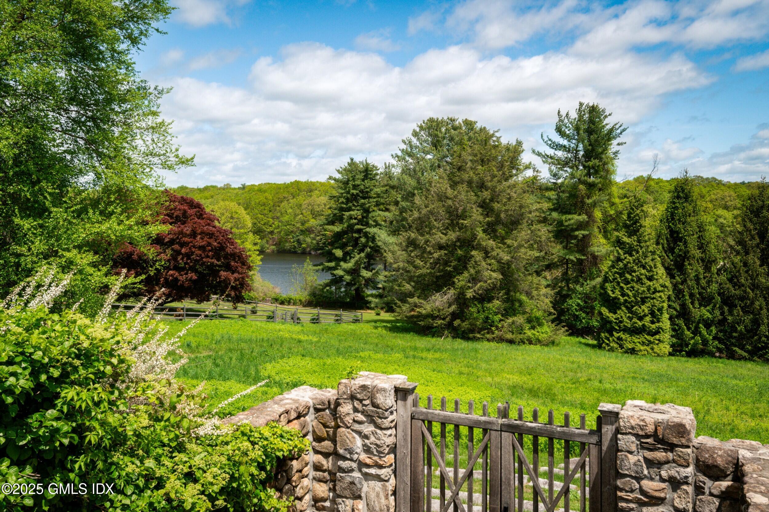 945 Oenoke Ridge New Canaan, CT 06840 - Photo 79 of 94 a view of a garden with lawn chairs