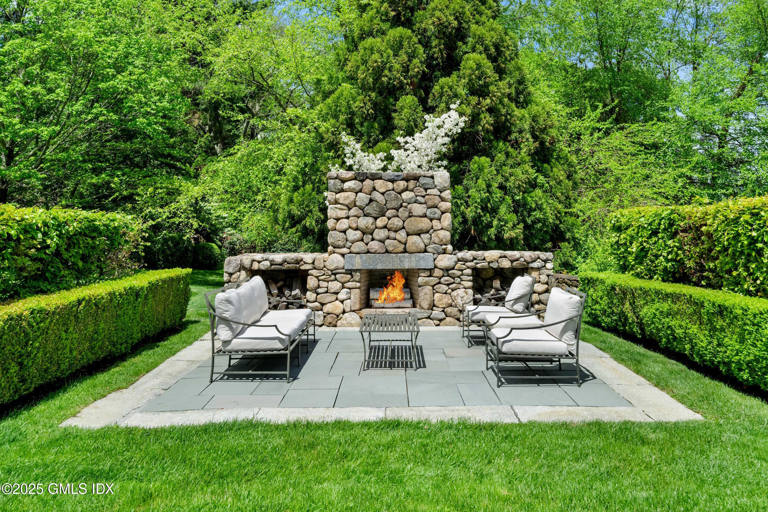 945 Oenoke Ridge New Canaan, CT 06840 - Photo 9 of 94 a view of a patio with chairs and a yard