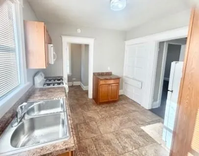 a view of kitchen with sink and natural light