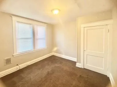 an empty room with a empty space and windows