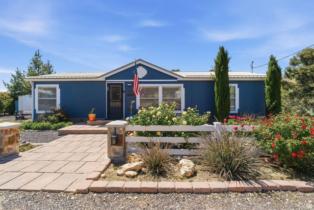 327 North Lodge Road Central, UT 84722 - Photo 1 of 45 Blue exterior featuring white trim and a metal roof