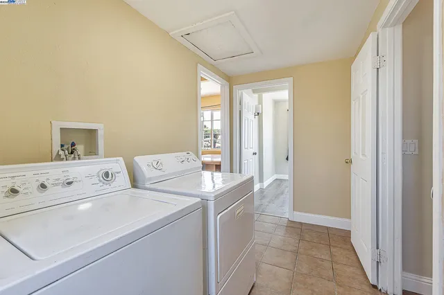 a view of washer and dryer with kitchen in the background
