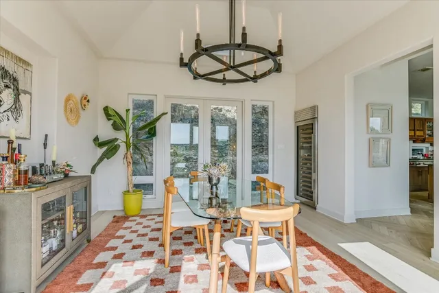 a view of a dining room with furniture wooden floor and chandelier
