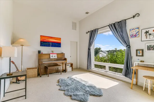 a bedroom with furniture and a large window