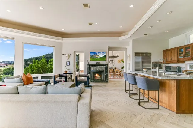 a living room with fireplace furniture and a large window