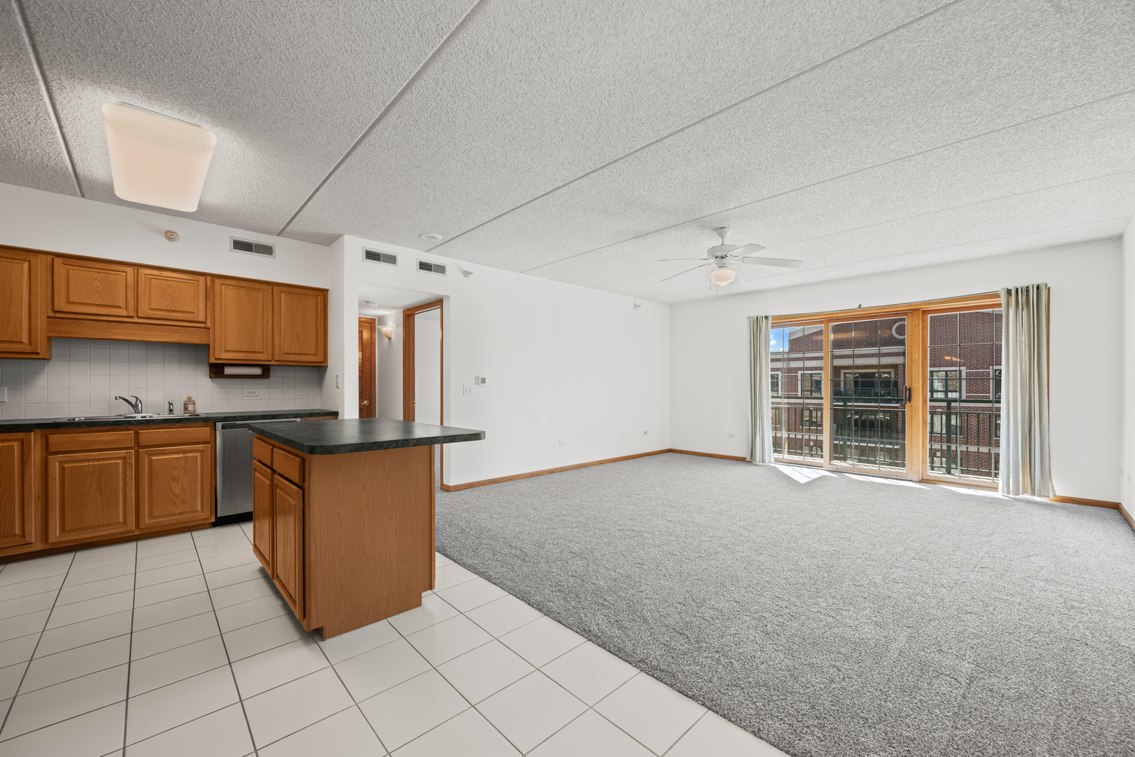 750 Pearson Street, Unit 812 Des Plaines, IL 60016 - Photo 2 of 15 a view of kitchen with granite countertop cabinets and outdoor space