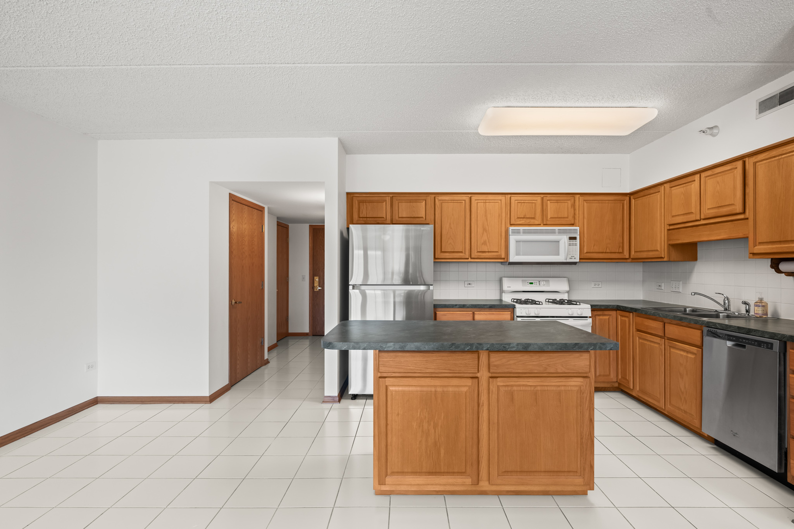 750 Pearson Street, Unit 812 Des Plaines, IL 60016 - Photo 5 of 15 a kitchen with stainless steel appliances granite countertop a sink stove and cabinets