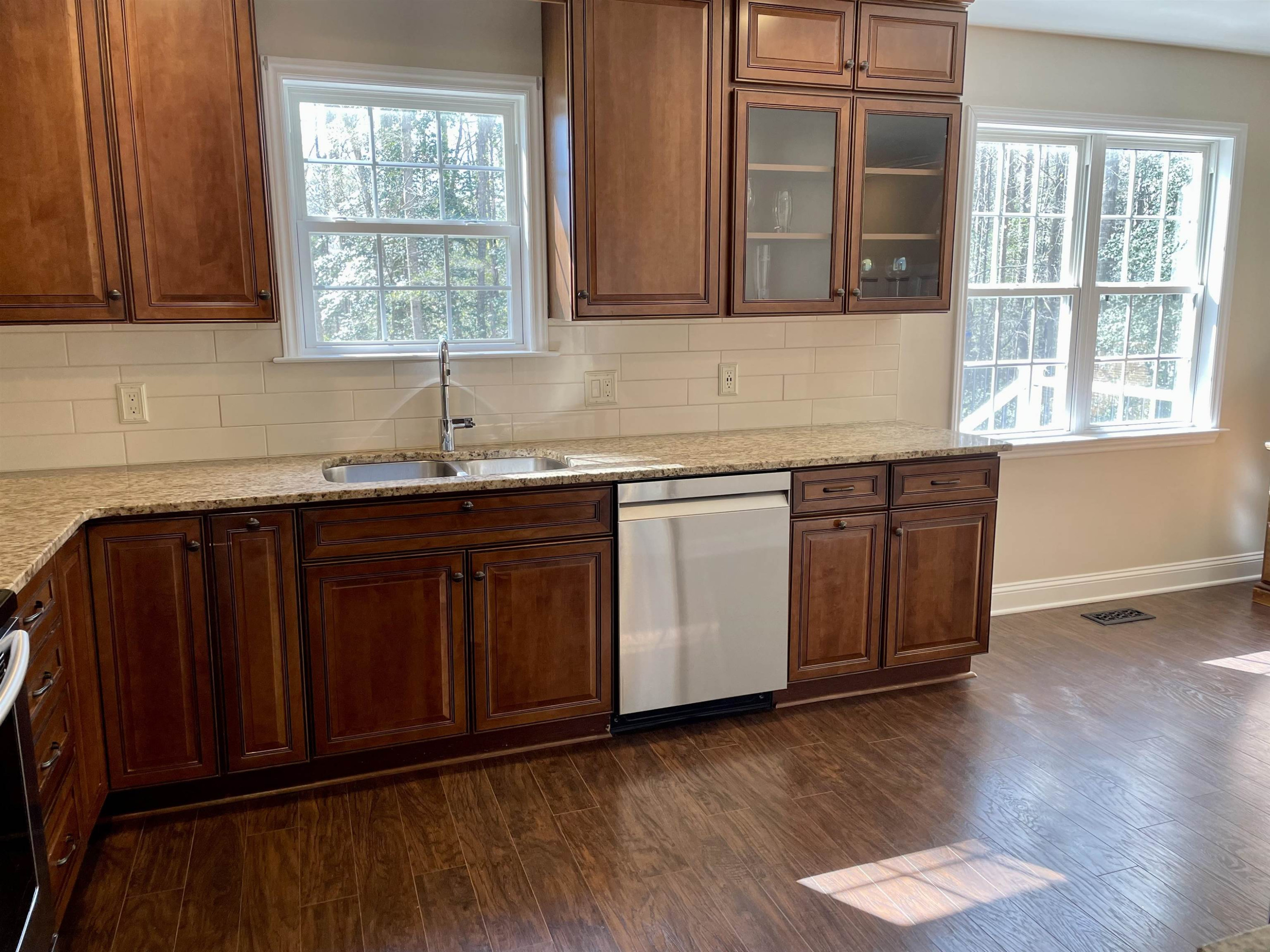 128 Deerview Drive Willow Spring, NC 27592 - Photo 13 of 34 a kitchen with stainless steel appliances granite countertop wooden cabinets a sink and dishwasher with wooden floor