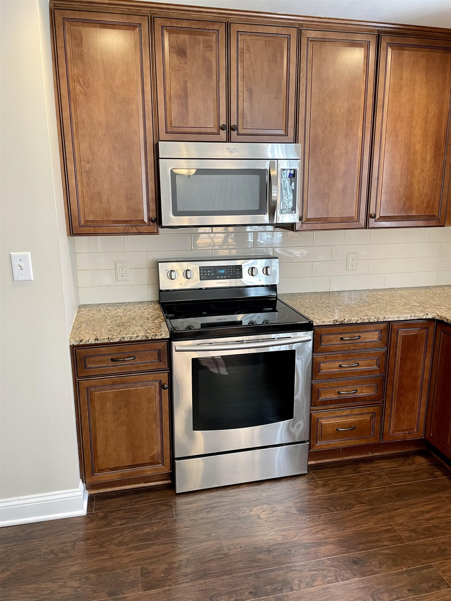 128 Deerview Drive Willow Spring, NC 27592 - Photo 15 of 34 a kitchen with granite countertop wooden cabinets and stainless steel appliances