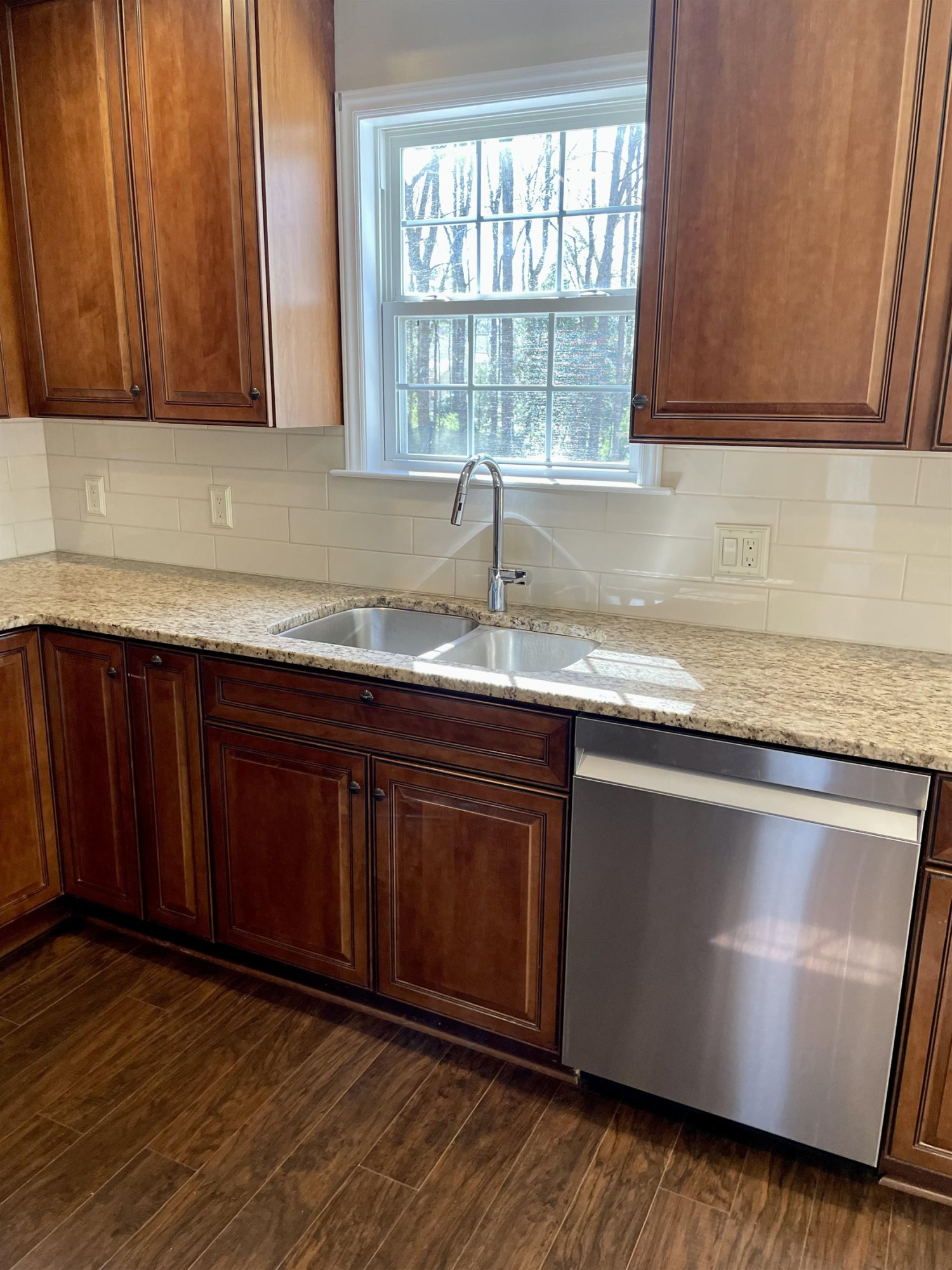 128 Deerview Drive Willow Spring, NC 27592 - Photo 16 of 34 a kitchen with granite countertop wooden cabinets a sink and dishwasher