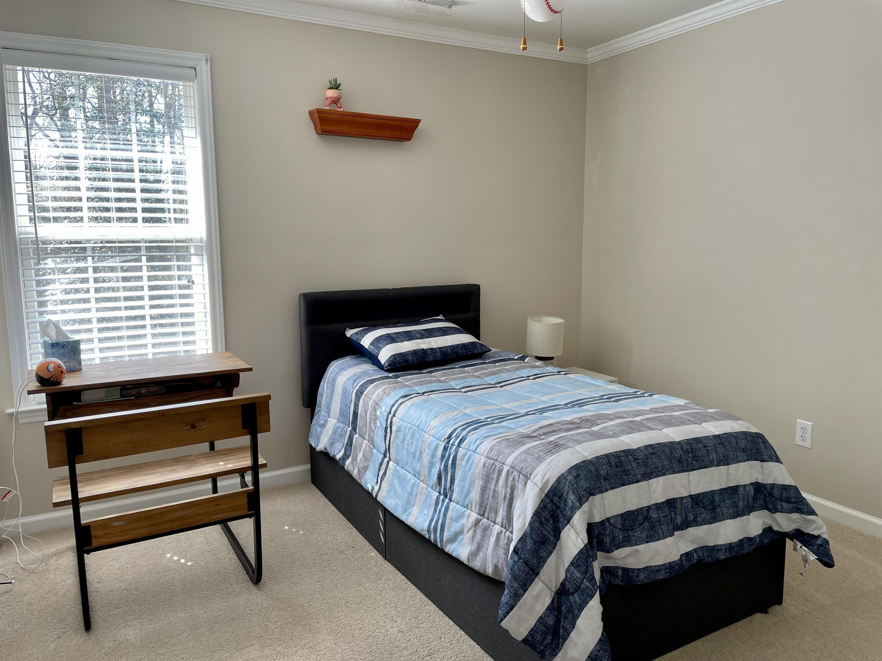 128 Deerview Drive Willow Spring, NC 27592 - Photo 26 of 34 a bedroom with a bed and a window