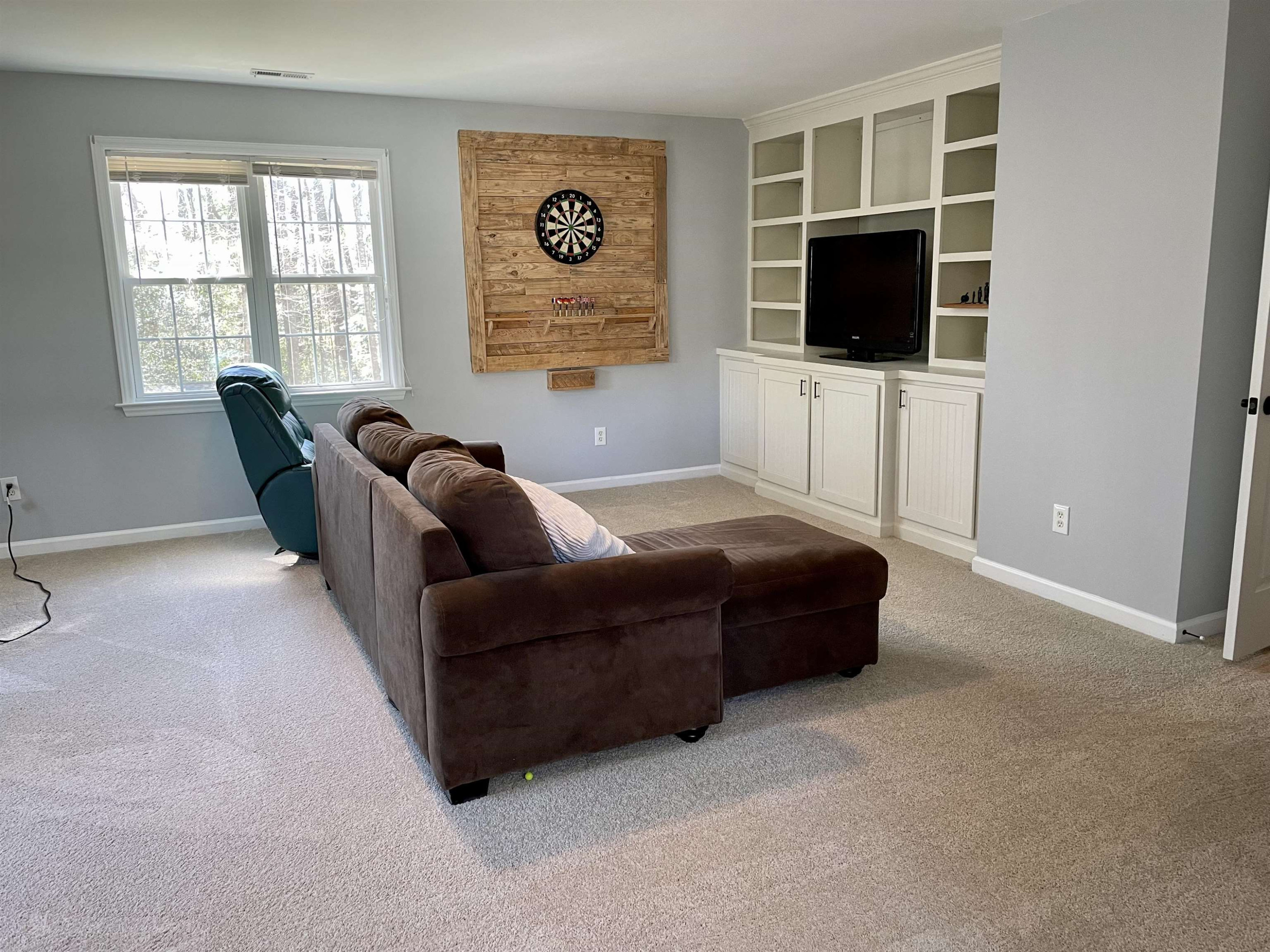 128 Deerview Drive Willow Spring, NC 27592 - Photo 29 of 34 a living room with furniture and a flat screen tv