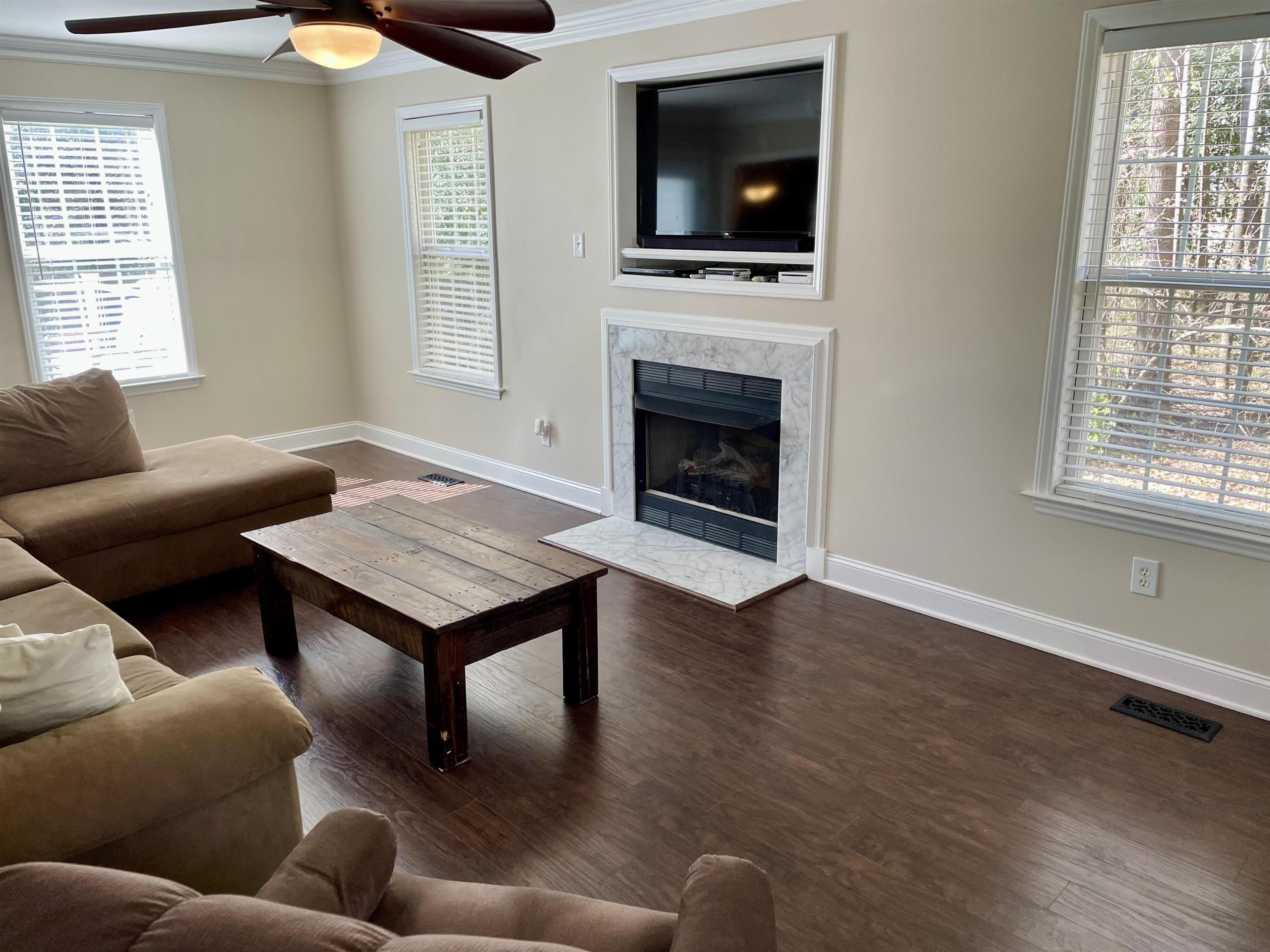 128 Deerview Drive Willow Spring, NC 27592 - Photo 8 of 34 a living room with furniture a flat screen tv and a fireplace