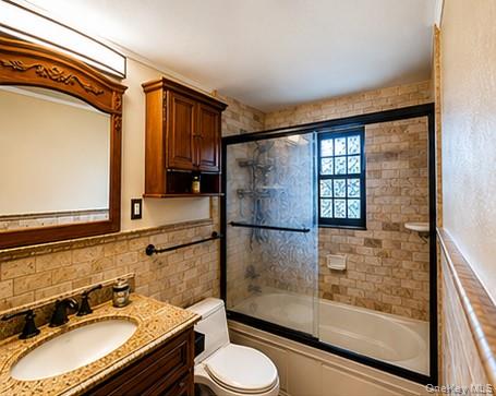 335 Mariners Way Copiague, NY 11726 - Photo 7 of 12 a bathroom with a granite countertop sink toilet and shower