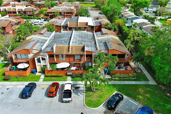 an aerial view of a house with a garden and lake view