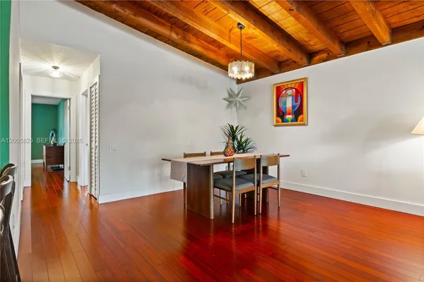 a dining room with furniture and wooden floor