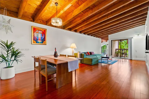 a view of a dining room with furniture window and wooden floor