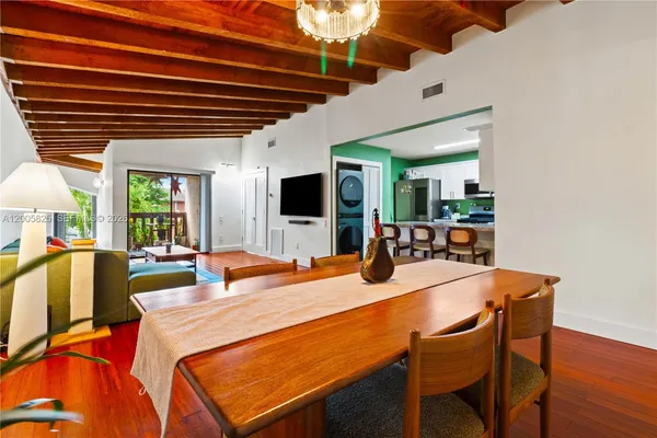 a dining room with a table chairs and a kitchen