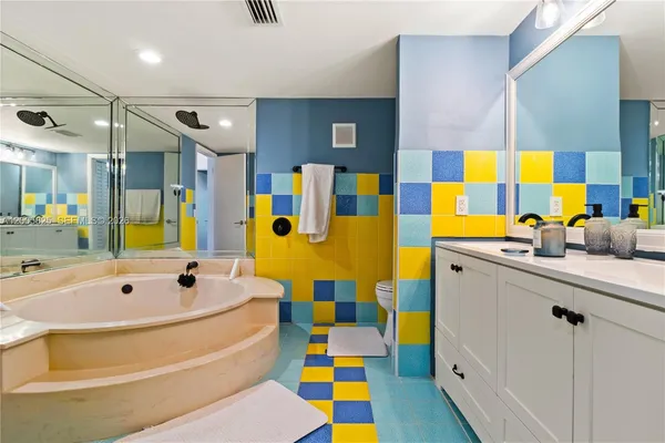 a bathroom with a tub sink and mirror