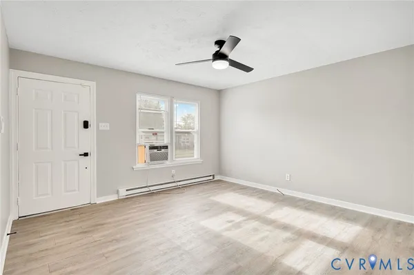 a kitchen with a stove a sink a refrigerator dining table and chairs