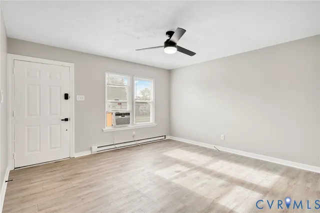 a kitchen with a stove a sink a refrigerator dining table and chairs
