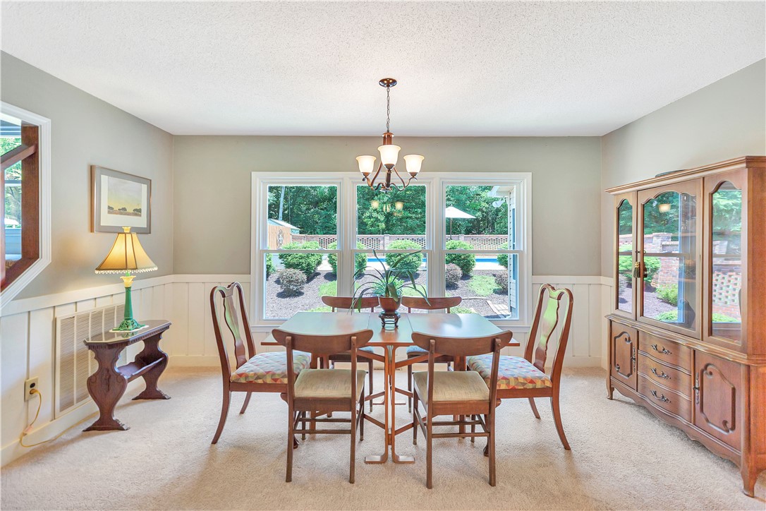 910 Chantilly Lane Anderson, SC 29625 - Photo 8 of 38 A well-lit dining area offers views of the verdant outdoor space through large windows.