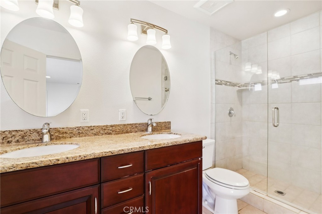 12106 Old River School Road, Unit G Downey, CA 90242 - Photo 11 of 22 a bathroom with a granite countertop sink mirror toilet and shower