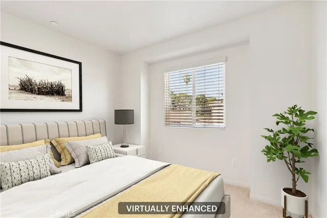 a bedroom with a large bed and a potted plant